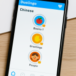 A smartphone displaying Duolingo’s Chinese learning interface with colorful lesson icons for Basics, Greetings, and People.